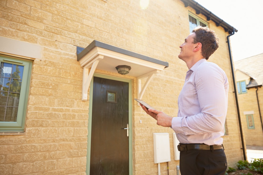 Man looking at house door