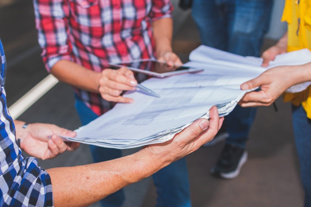 Hands holding plans and documents