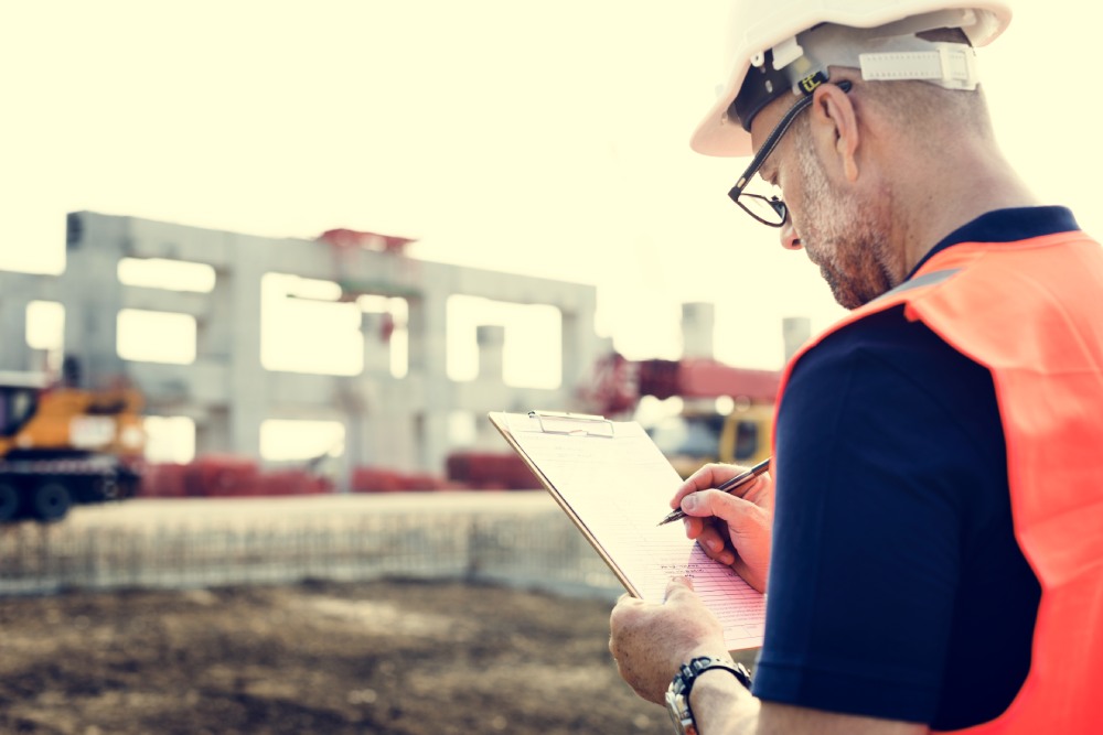 Construction worker inspecting site